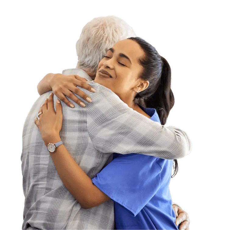 A nurse hugs an elderly man, symbolizing support and kindness in a healthcare setting.